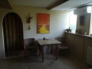 a dining room with a table and two chairs at South African Room in Westbeemster +7 photos