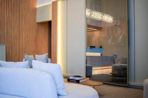 a bedroom with a white bed and a mirror at Farms Hotel in Coribe +30 photos