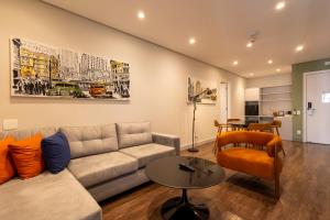 a living room with a couch and a table at Hotel Transamerica Berrini in São Paulo