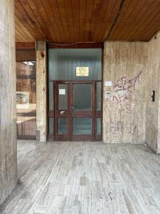 an empty building with a door with graffiti on it at Ultracentral Modern Apartment Toma Caragiu, Ploiesti in Ploieşti