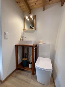 a bathroom with a white toilet and a sink at Tiny Surf in Punaauia +8 photos