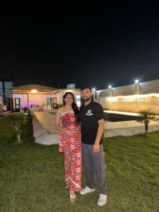 a man and woman posing for a picture at night at Kinaara farms in Dāsna