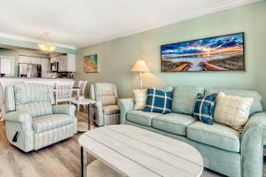 a living room with a couch and chairs and a table at Sands Beach Club 1015 - Bright Shores in Myrtle Beach