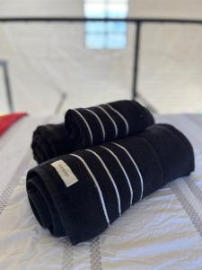 a pair of black towels on a bed at Chalé Exclusivo com Spa e Vista Mágica, Top Urubici in Urubici