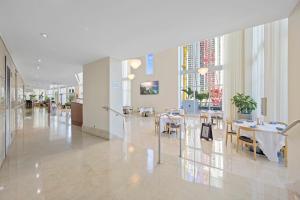 a dining room with tables and chairs in a building at Marenas Resort PRIVATE UNIT daily refresh not included in Sunny Isles Beach +30 photos