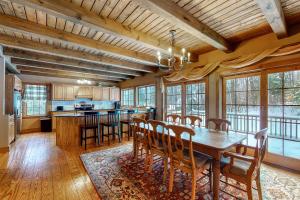 a large kitchen with a wooden table and chairs at Moose Lodge Unit A in Newry