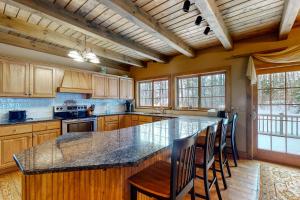 a kitchen with a large island with chairs in it at Moose Lodge Unit A in Newry