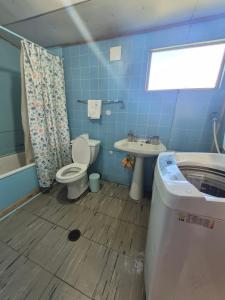 a bathroom with a toilet and a sink and a tub at Cabana El Sauce in San Patricio +22 photos