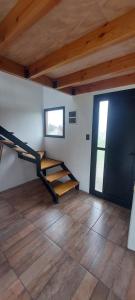 une pièce avec un escalier dans une pièce avec un parquet dans l'établissement Cabaña Linna, à El Hoyo