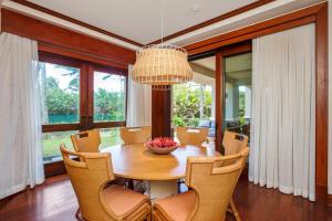 a dining room with a table and chairs and a chandelier at Montage Kapalua Bay 2 Free Rental Cars KBM Resorts Hale Mala At Montage Kapalua Bay Oceanfront Property 2 Units 6 Bedrooms ML-1161 in Honokahua