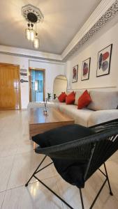 a living room with a couch and a table at Cosy and central Condo with terace in Rabat
