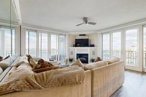 a living room with a large couch and windows at Emerson Towers 504 in Ocean City