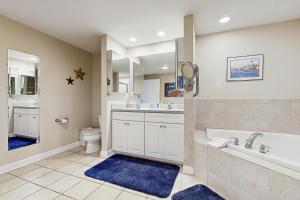 a bathroom with a tub and a toilet and a sink at Emerson Towers 504 in Ocean City +23 photos