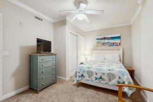 a bedroom with a bed and a ceiling fan at Emerson Towers 504 in Ocean City