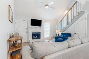 a living room with a couch and a fireplace at Leeward Cove A8 in Padre Island
