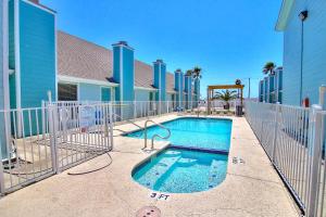 a swimming pool with a slide in front of a building at Leeward Cove A8 in Padre Island