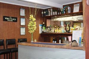 a bar in a restaurant with a counter and chairs at Cobram Colonial Motor Inn in Cobram