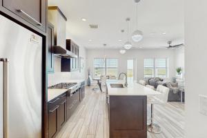 a kitchen and living room with a sink and a stove at Padre Villa 104 in Padre Island