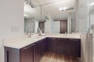 a bathroom with two sinks and a large mirror at Padre Villa 104 in Padre Island +16 photos