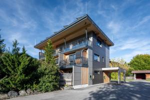 a building with a balcony on the side of it at TinyHome Singer - inclusive private Sauna in Ehenbichl