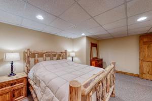 a bedroom with a wooden bed in a room at Moose Lodge Unit B in North Bethel