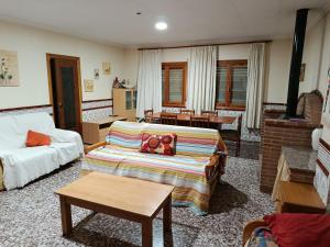 a living room with a couch and a table at turismo rural la solana in Murcia +12 photos