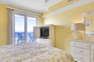 a bedroom with a bed and a tv and a window at Adagio 503 in Ocean City +18 photos