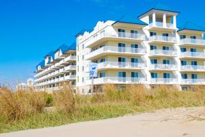 a large white building on the beach next to the sand at Adagio 503 in Ocean City