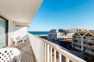a balcony with a view of the ocean and buildings at Ocean Place 401 in Ocean City