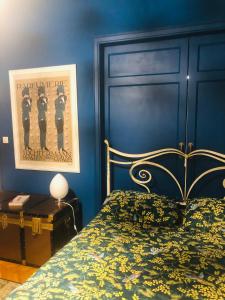 a bedroom with a bed and a blue wall at Casa D Azeglio in Turin +13 photos