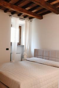 En eller flere senge i et værelse på Residenze Il Convento Serra Alta