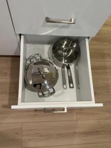 a cabinet with two pans and a clock in it at Comfy Apartment in Moncton +16 photos