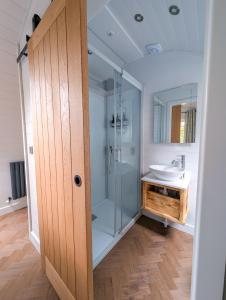 a bathroom with a glass shower and a sink at Liba Vineyard in Porton +30 photos