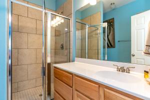 a bathroom with a sink and a shower at NPI Hideaway Stay in Padre Island +15 photos