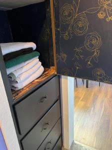 a bathroom with a dresser with towels on it at Pet friendly newly renovated home in Central Okc in Oklahoma City