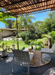 a white bench under a pergola on a patio at Casa Positano Pipa in Pipa