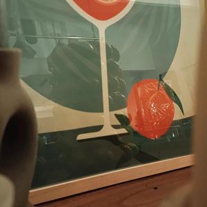 a painting of an orange with a stick in it at La Parenthèse Picarde Maison de ville 2 chambres in Troissereux