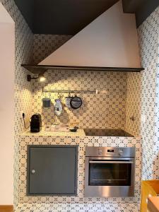 a kitchen with a stainless steel stove top oven at Appartamento a due passi dal mare in Genova