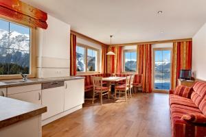 a kitchen and living room with a couch and a table at Appartements Luegeck in Hollersbach im Pinzgau