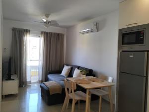 a living room with a table and a couch at Oliva Home in Los Cristianos