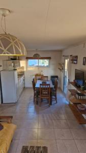 a kitchen and living room with a table and chairs at Cabaña Oliva in San Rafael