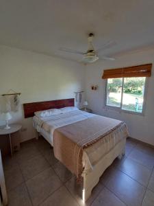 a bedroom with a large bed and a window at Cabaña Oliva in San Rafael