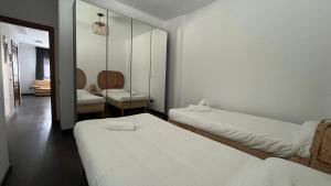 a room with two beds and a mirror at la casa de pozo1 in Pozo Izquierdo