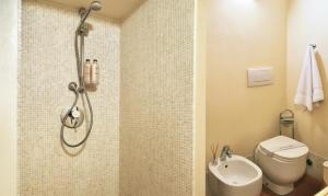 a bathroom with a shower and a toilet and a sink at Le Dimore della Seta in Lucca