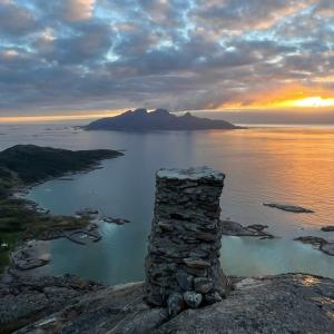 a stone pillar sitting on top of a hill with the ocean at Leilighet i i vakre Skivika, Bodø Gratis parkering og rolige omgivelser nært sentrum in Bodø +5 photos