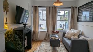 a living room with a couch and a flat screen tv at 1780 Green Street in Dingle