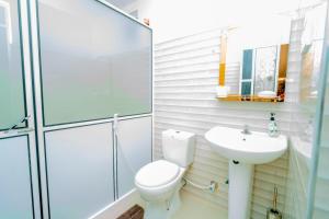 a bathroom with a toilet and a sink at Joy Villa Garden in Batticaloa +6 photos