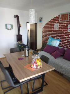 a living room with a table and a couch at Crni in Gdinj