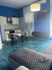 a kitchen and dining room with a table and chairs at Tower casa vacanze 2 in Anzio