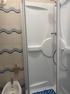a small bathroom with a toilet and a shower at Tower casa vacanze 2 in Anzio
